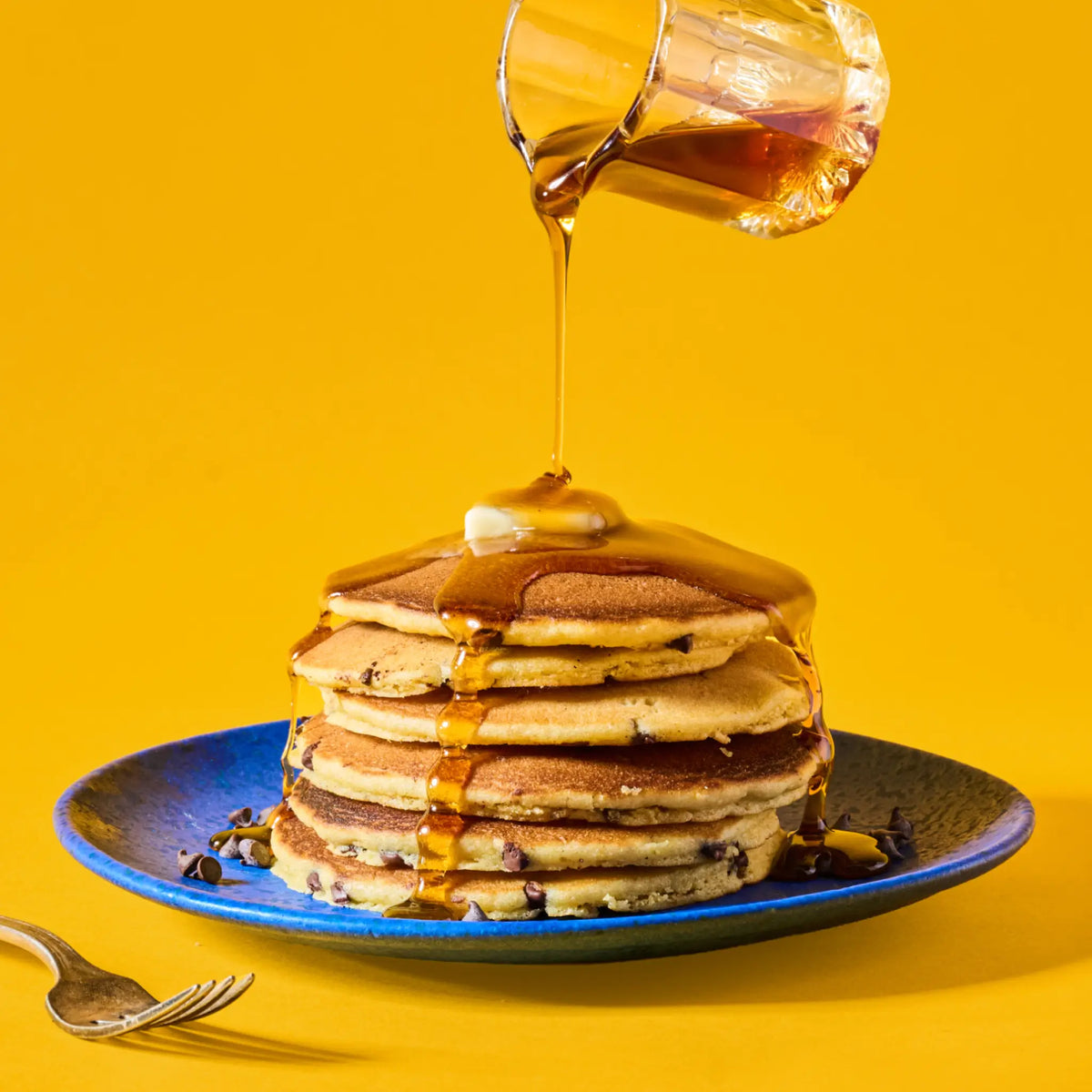 maple syrup drizzled chocolate chip pancakes
