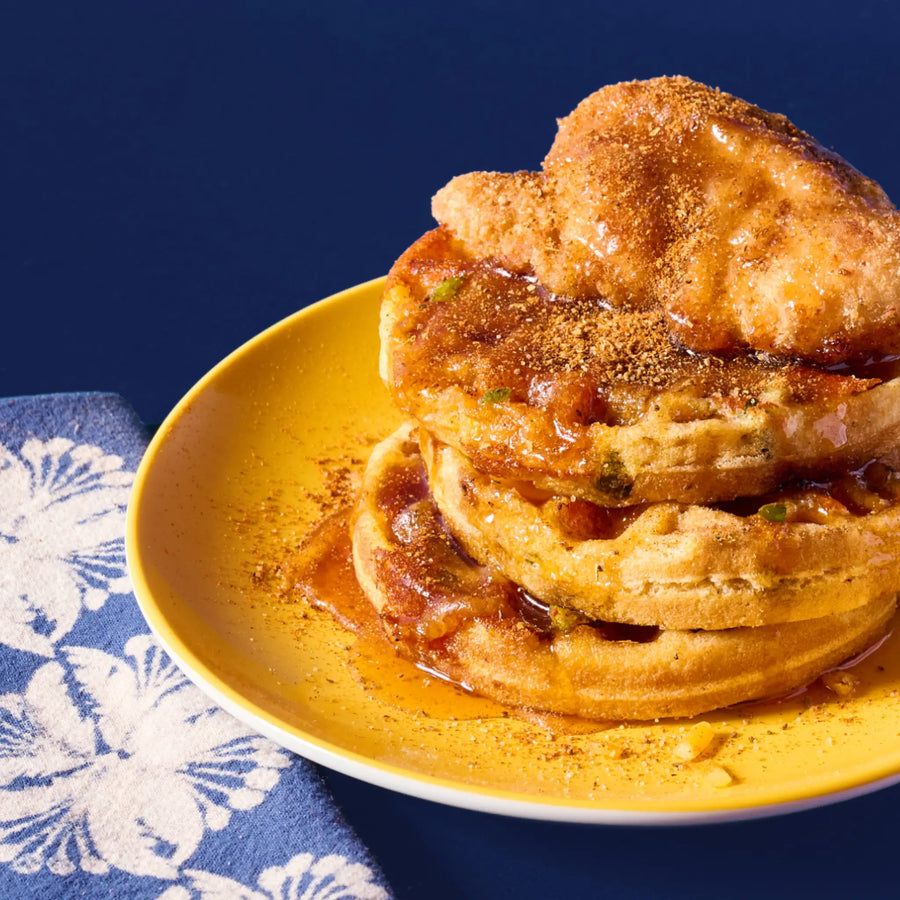 stack of waffles topped with chicken and old bay